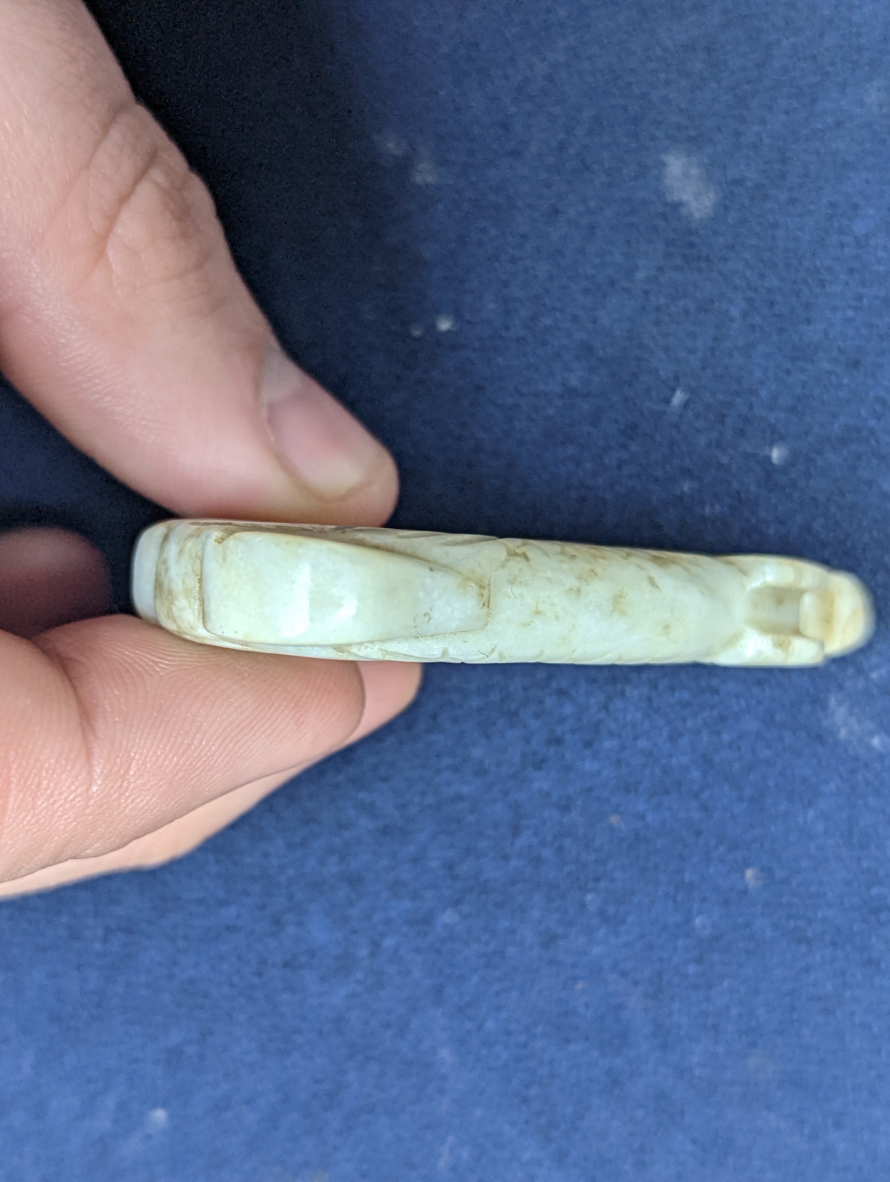 A Chinese white and black jade ‘dragon-fish’ plaque, 19th/20th century, 6cm